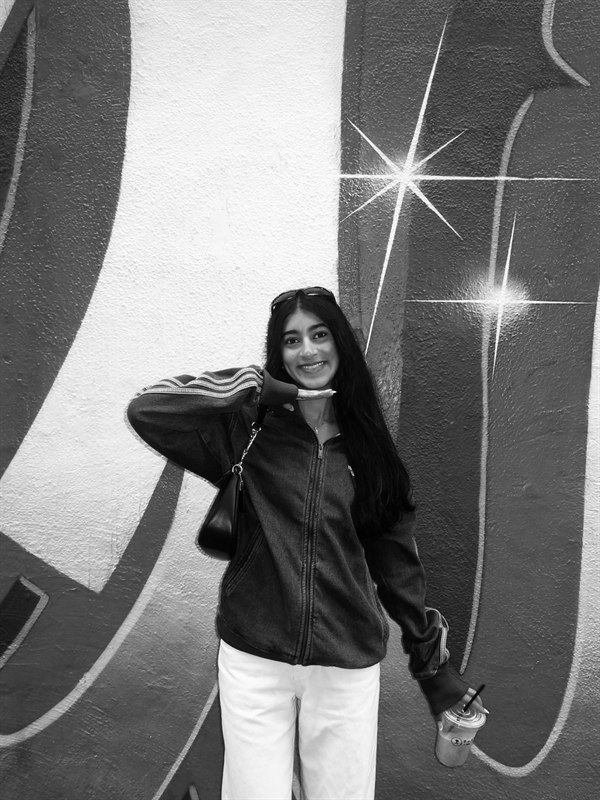 Aashvi posing in front of mural